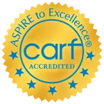 Gold seal with blue stars and text, "CARF Accredited, Aspire to Excellence.