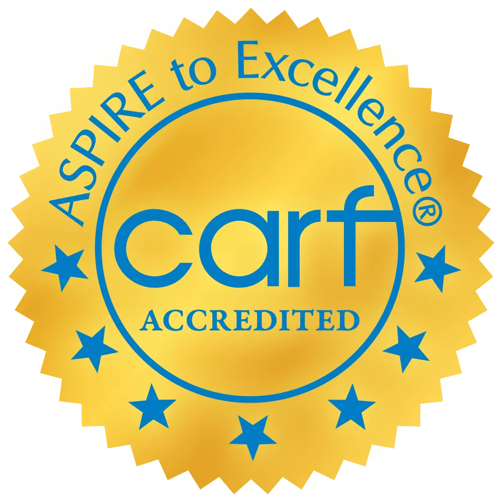 Gold seal with blue stars and text, "CARF Accredited, Aspire to Excellence.