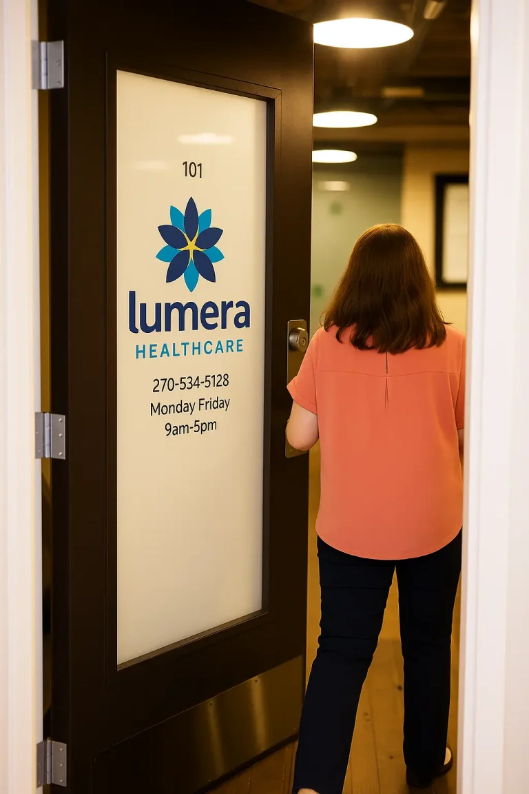 A woman enters a door labeled "Lumera Healthcare" with contact details and hours.