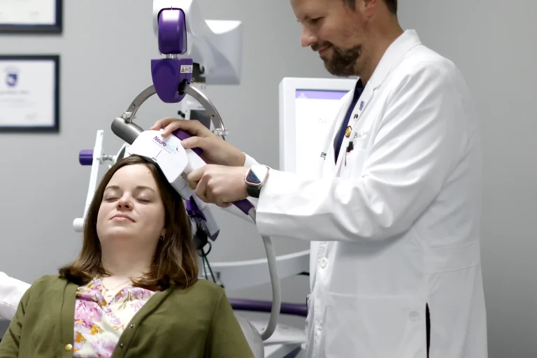 Mental Health Treatment A doctor administers transcranial magnetic stimulation to a relaxed patient.