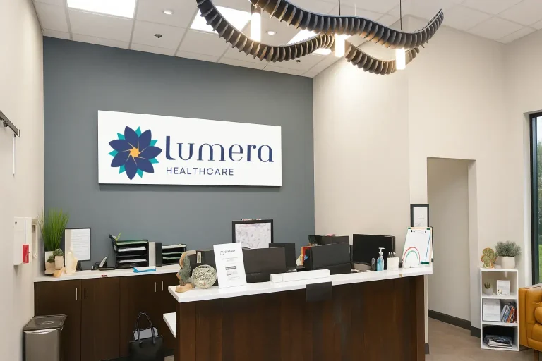 Lumera Healthcare Office Reception area of Lumera Healthcare with front desk and wall sign.